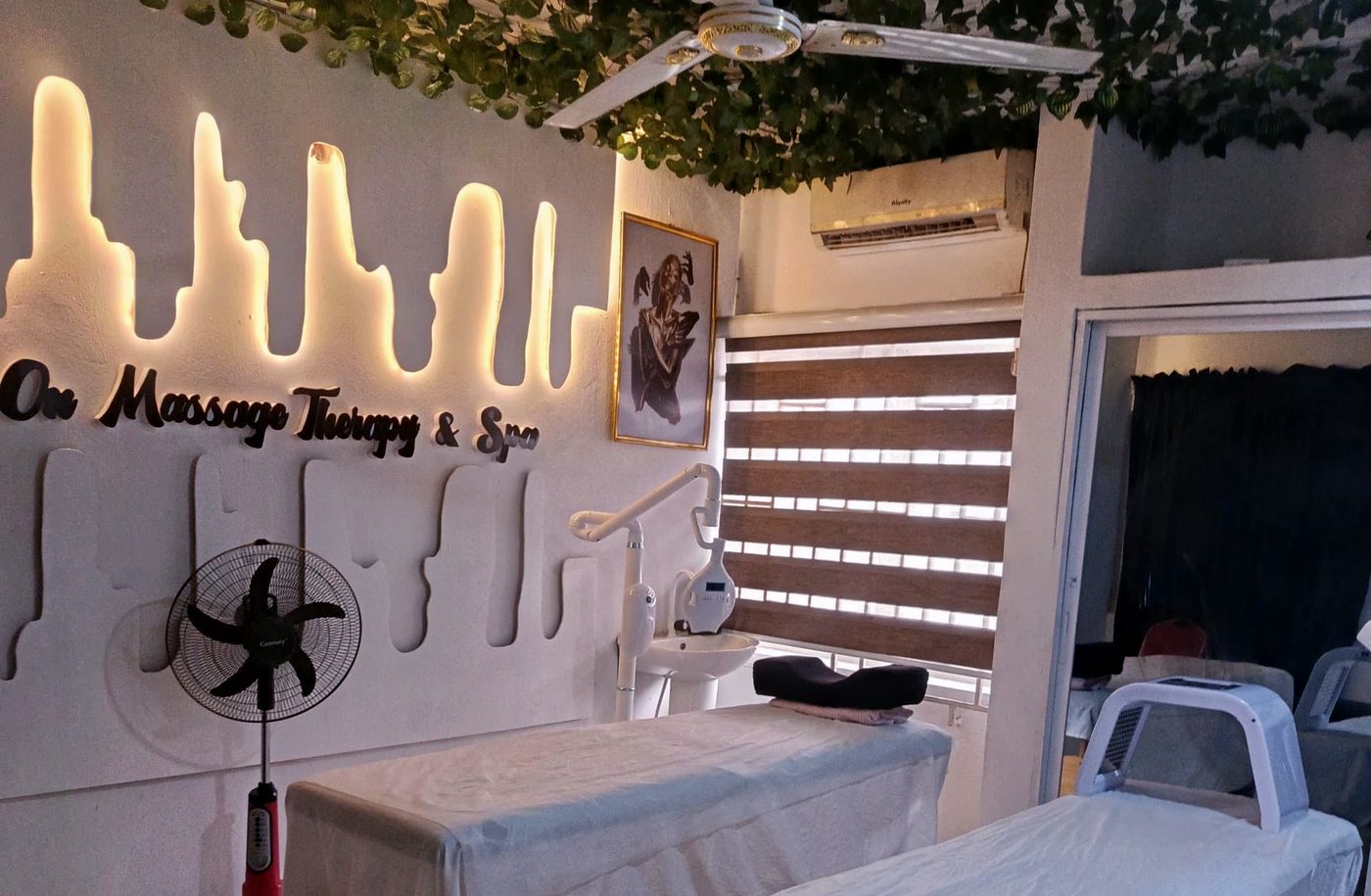 The lit Dot On Massage Therapy & Spa sign in the treatment room