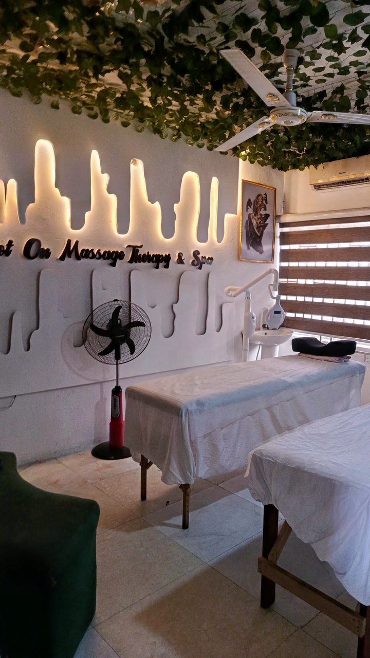 The lit Dot On Massage Therapy & Spa sign